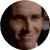 a close up of a man 's face in a circle with a smile on his face .