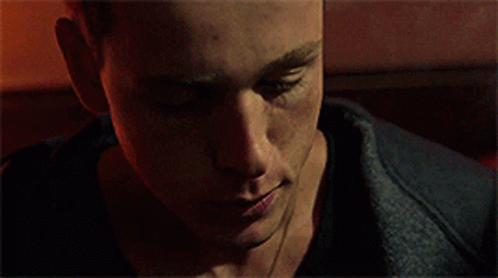 A Close Up Of A Man 'S Face In A Dark Room . GIF