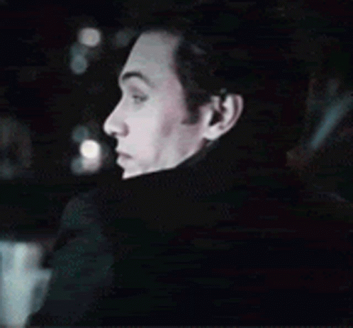 a close up of a man 's face in a dark room .