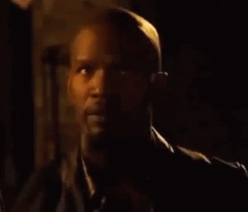 A Close Up Of A Man 'S Face In A Dark Room . GIF
