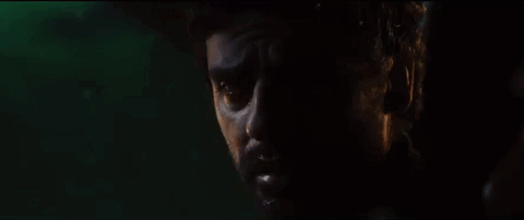 a close up of a man 's face in a dark room .