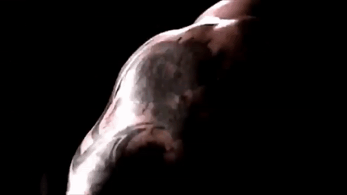A Close Up Of A Man 'S Face In A Dark Room With A Black Background . GIF