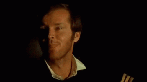 A Close Up Of A Man 'S Face In A Dark Room With A Black Background . GIF