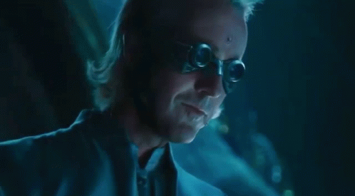 A Close Up Of A Man 'S Face In A Dark Room With A Blue Background . GIF