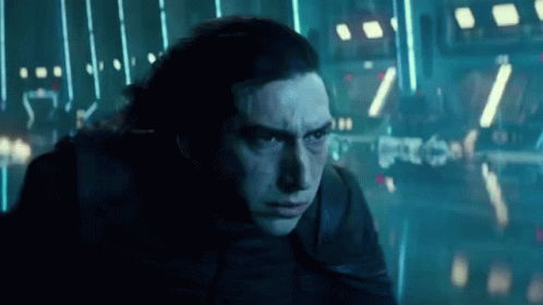 A Close Up Of A Man 'S Face In A Dark Room With Lights . GIF