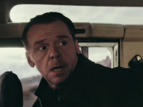 A Close Up Of A Man 'S Face In A Dark Room GIF