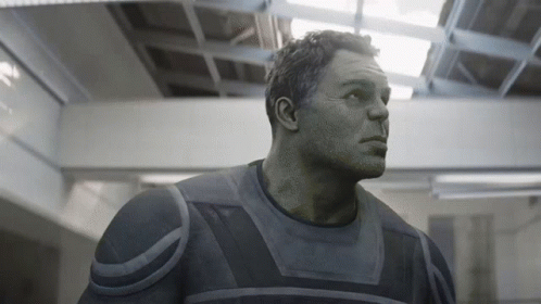 A Close Up Of A Man 'S Face In A Gray Suit GIF