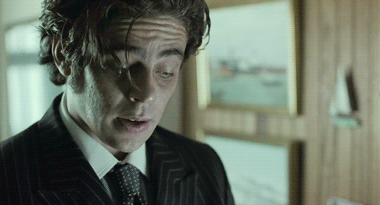 A Close Up Of A Man 'S Face In A Suit And Tie GIF