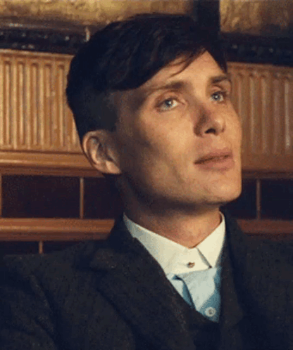 A Close Up Of A Man 'S Face In A Suit And Tie GIF