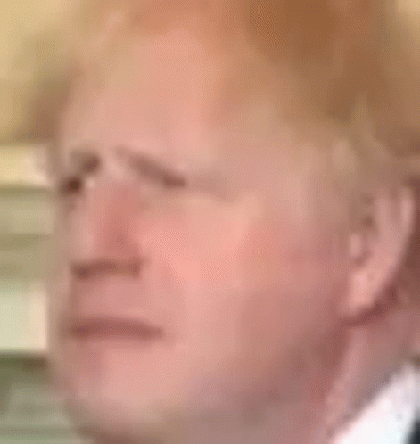 A Close Up Of A Man 'S Face In A Suit And Tie With A Serious Look On His Face . GIF
