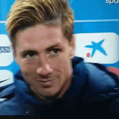 A Close Up Of A Man 'S Face In Front Of A Blue Background GIF