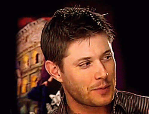 A Close Up Of A Man 'S Face In Front Of A Building GIF