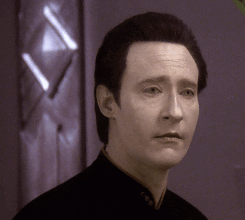 A Close Up Of A Man 'S Face In Front Of A Door GIF