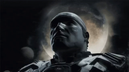 A Close Up Of A Man 'S Face In Front Of A Full Moon In A Dark Room . GIF