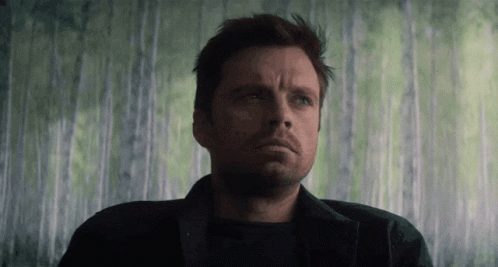 A Close Up Of A Man 'S Face In Front Of A Green Wall GIF