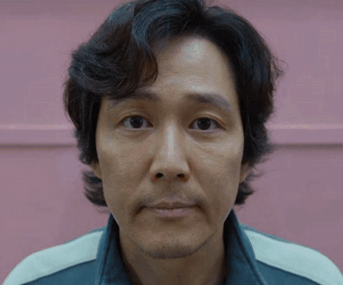 A Close Up Of A Man 'S Face In Front Of A Pink Wall GIF