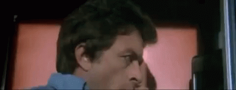 A Close Up Of A Man 'S Face In Front Of A Red Background . GIF