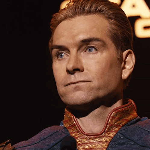 A Close Up Of A Man 'S Face In Front Of A Star Wars Logo GIF
