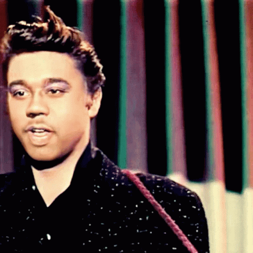 A Close Up Of A Man 'S Face In Front Of A Striped Background GIF