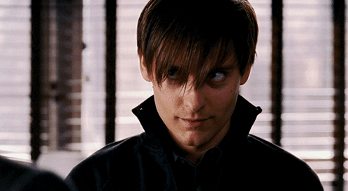 A Close Up Of A Man 'S Face In Front Of A Window With Blinds GIF