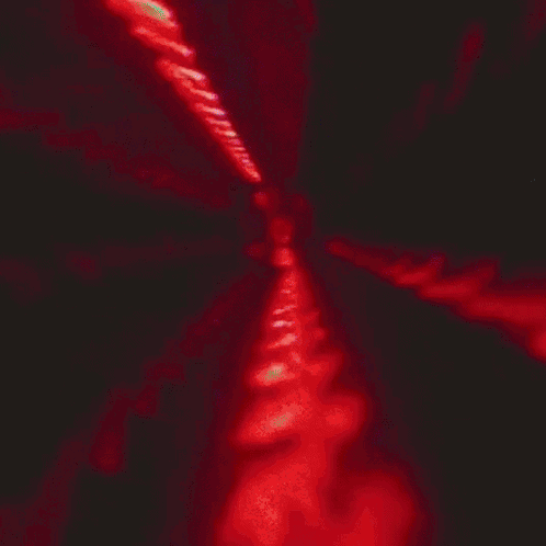 A Close Up Of A Man 'S Face In Red Light GIF