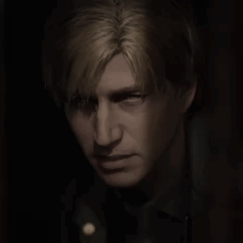 A Close Up Of A Man 'S Face In The Dark GIF