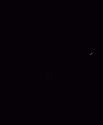 A Close Up Of A Man 'S Face In The Dark GIF