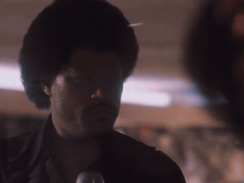 A Close Up Of A Man 'S Face In The Dark GIF