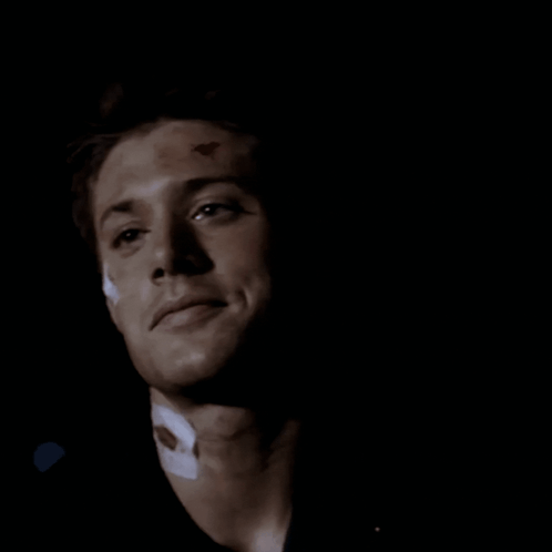 A Close Up Of A Man 'S Face In The Dark GIF