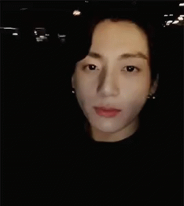 A Close Up Of A Man 'S Face In The Dark GIF