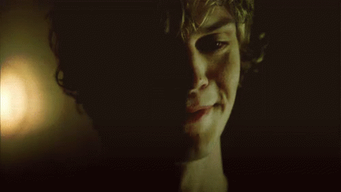 A Close Up Of A Man 'S Face In The Dark GIF