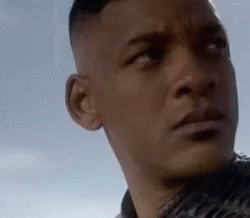 A Close Up Of A Man 'S Face Looking At The Camera . GIF