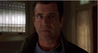 A Close Up Of A Man 'S Face Looking At The Camera . GIF