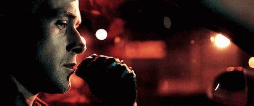 A Close Up Of A Man 'S Face Looking Out Of A Car Window GIF
