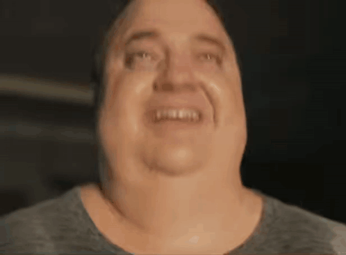 A Close Up Of A Man 'S Face Making A Funny Face And Smiling . GIF
