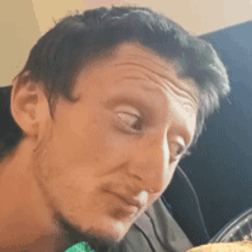 A Close Up Of A Man 'S Face Making A Funny Face While Looking At Something . GIF