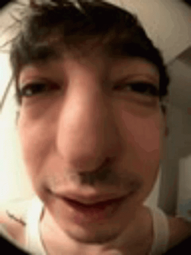 A Close Up Of A Man 'S Face Making A Funny Face With His Eyes Closed . GIF