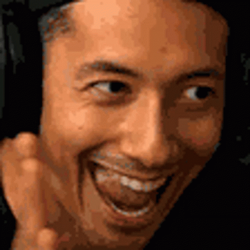 A Close Up Of A Man 'S Face Making A Funny Face With His Tongue Out . GIF