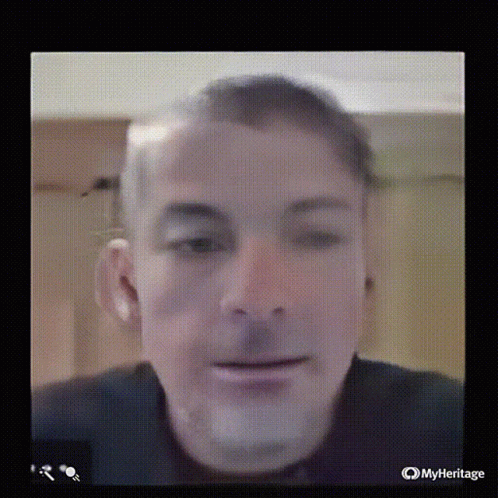 A Close Up Of A Man 'S Face On A Screen With Myheritage Written On The Bottom GIF