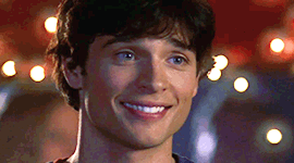 A Close Up Of A Man 'S Face Smiling With A Blurry Background GIF