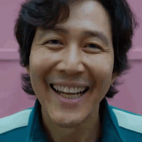 A Close Up Of A Man 'S Face Smiling With His Teeth Showing . GIF
