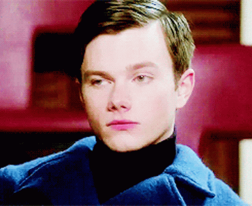 A Close Up Of A Man 'S Face Wearing A Blue Coat GIF