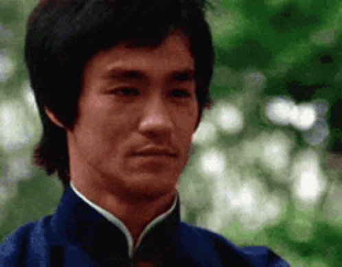 A Close Up Of A Man 'S Face Wearing A Blue Jacket . GIF