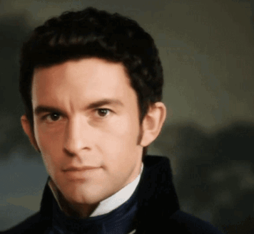 A Close Up Of A Man 'S Face Wearing A Blue Jacket GIF