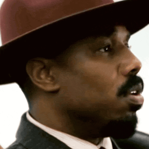 A Close Up Of A Man 'S Face Wearing A Hat GIF