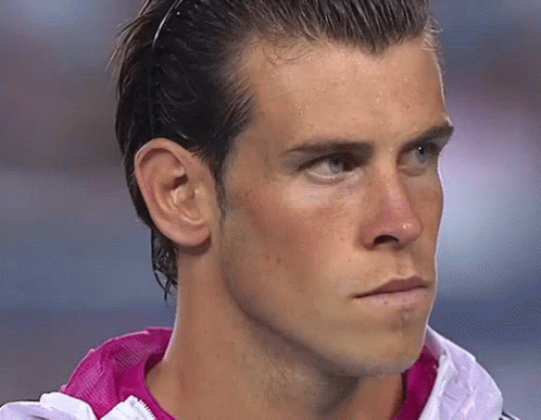A Close Up Of A Man 'S Face Wearing A Pink Jacket GIF