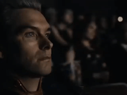 A Close Up Of A Man 'S Face While Watching A Movie . GIF