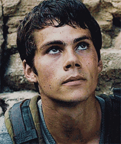A Close Up Of A Man 'S Face With A Backpack On GIF