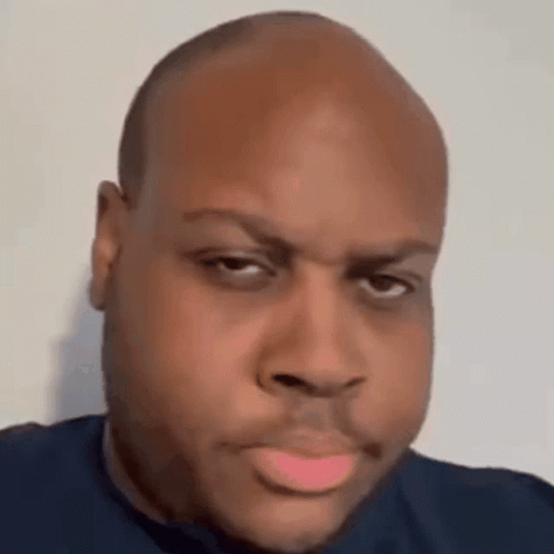 A Close Up Of A Man 'S Face With A Bald Head And A Pink Lip . GIF