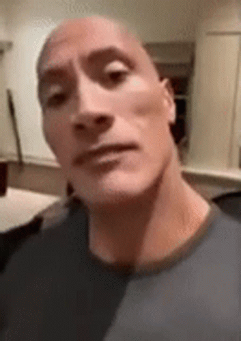 A Close Up Of A Man 'S Face With A Bald Head Making A Funny Face . GIF